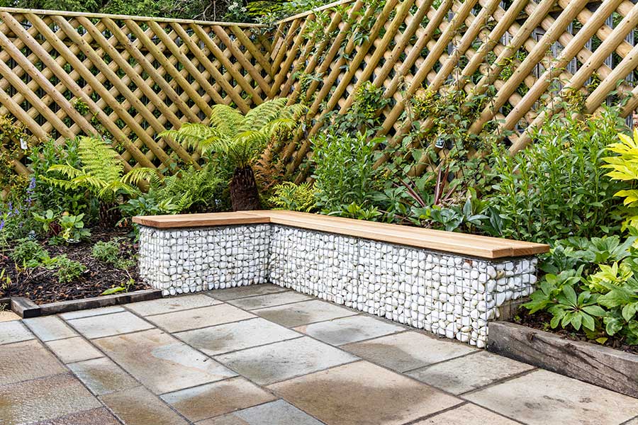 Stylish garden seat at Oxford Garden Centre created with gabion cages filled with pure white pebbles
