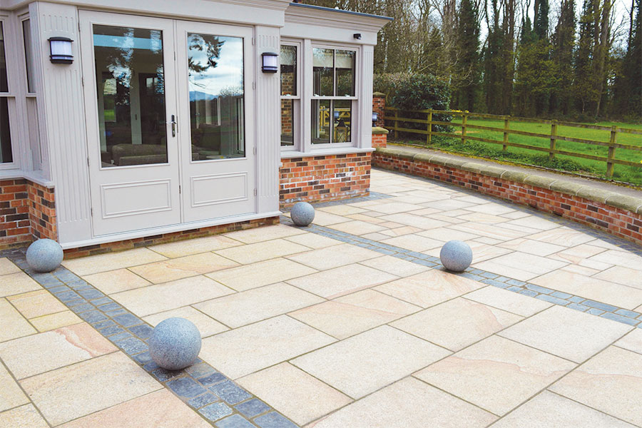 Lovely patio surrounding a conservatory featuring Digby granite paving slabs