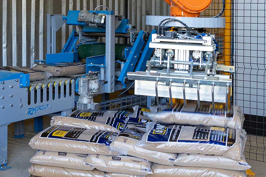 Robot stacking bags of sand on a pallet at AWBS