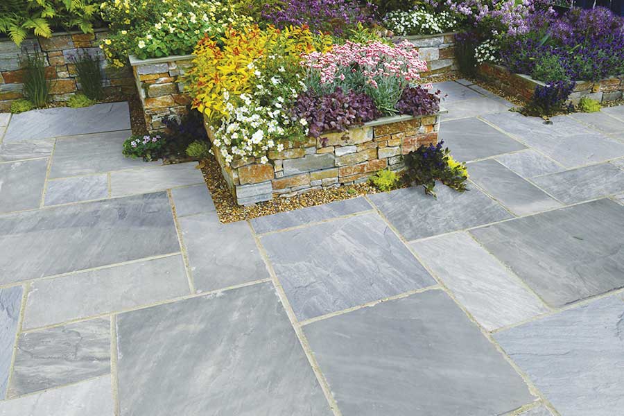 Lovely traditional patio with AWBS Exclusive Volcanic Ash natural sandstone paving in random pattern