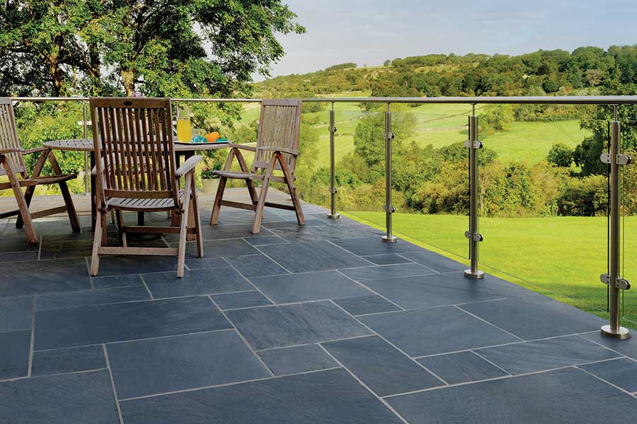 Brazilian slate patio with modern glass balustrade and stunning views of the country side beyond 