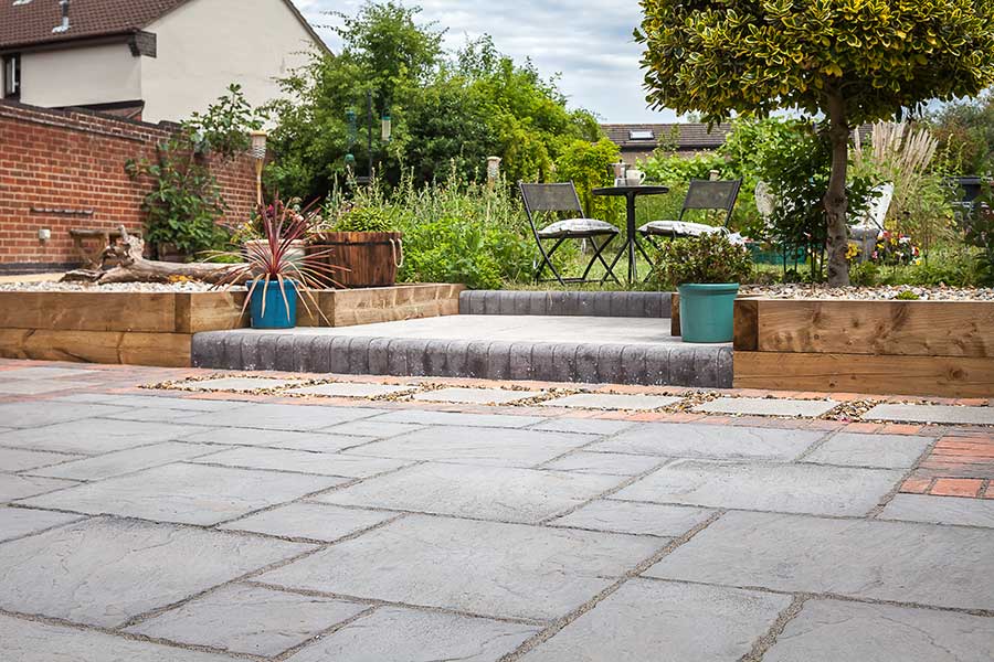 Smart patio paved with Brett Canterbury slate grey stone effect concrete paving