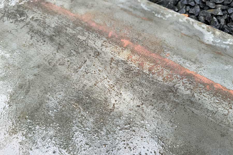 A Bradstone Metallics Lead porcelain paving slab when wet