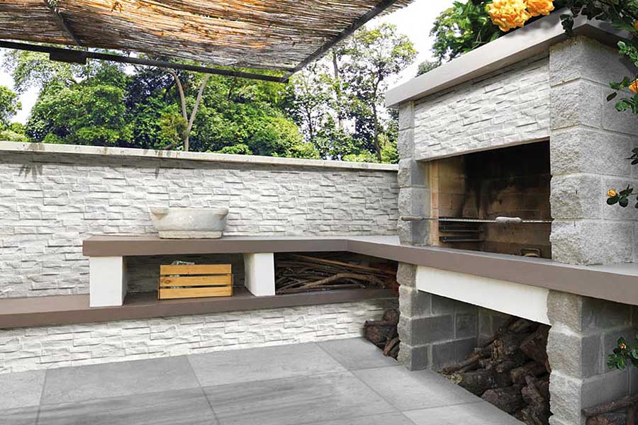 Walls of an outdoor bbq area clad with Pavestone Rock stack split face wall cladding