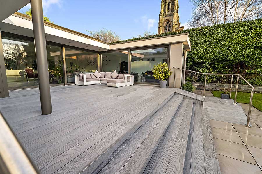 Large deck with steps clad with Composite Prime Redux Smoke composite decking boards