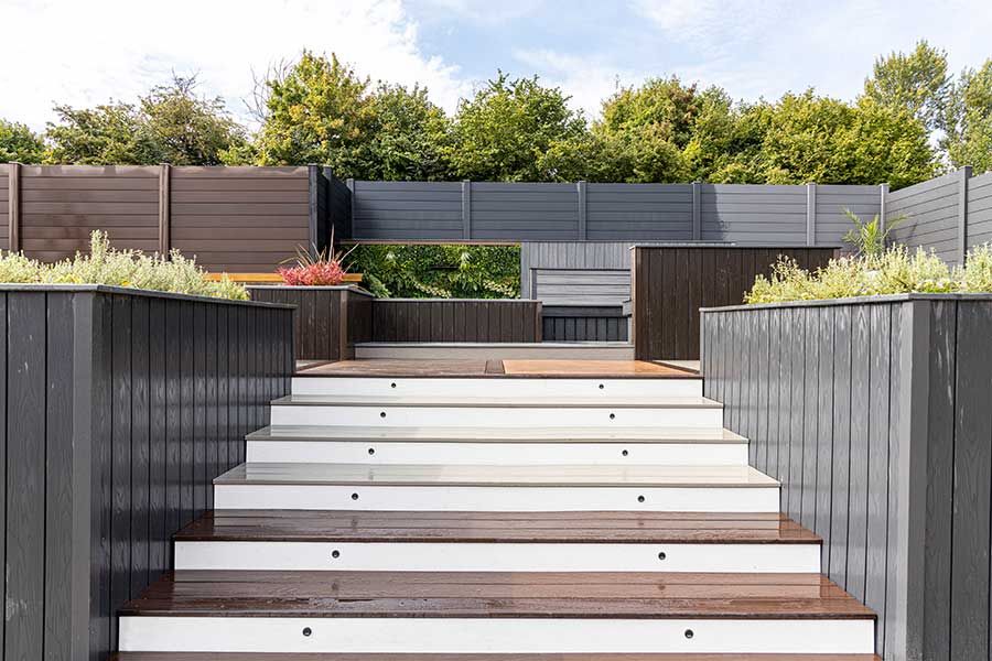 Large staircase for a deck created with composite decking boards and wall cladding