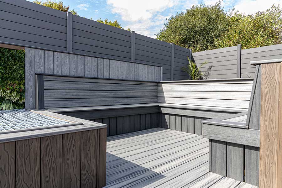 Stylish outdoor seating area created with composite cladding and decking boards by AWBS Oxford