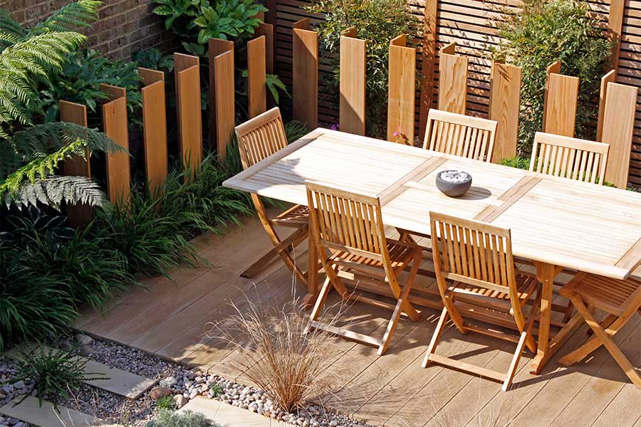 Honey coloured oak composite decking with a large dining table