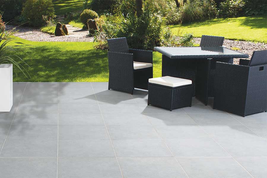 Modern patio featuring textured grey porcelain paving slabs