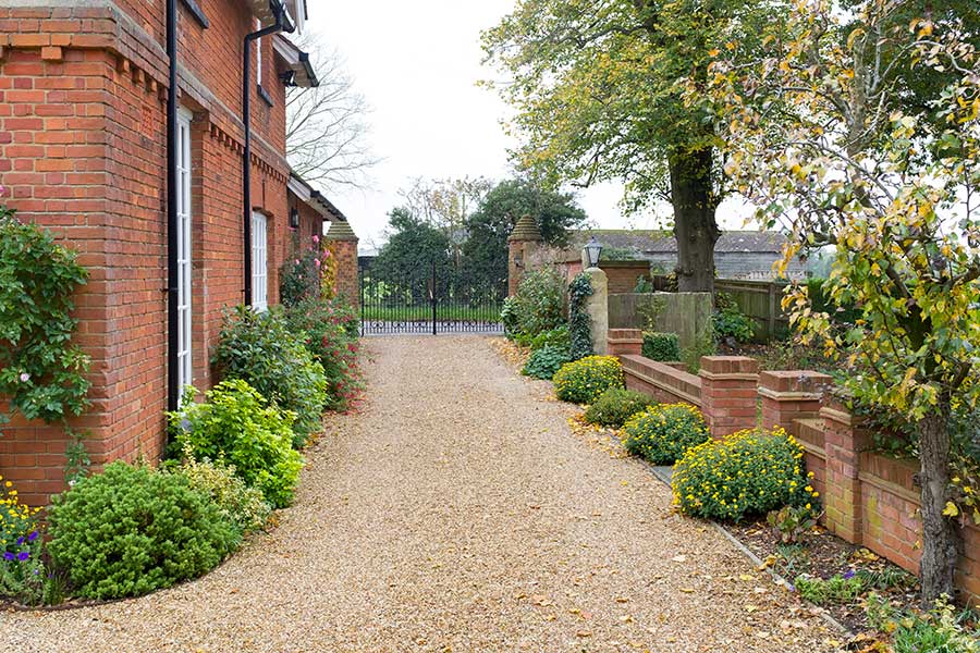 Traditional home with large gravel driveway