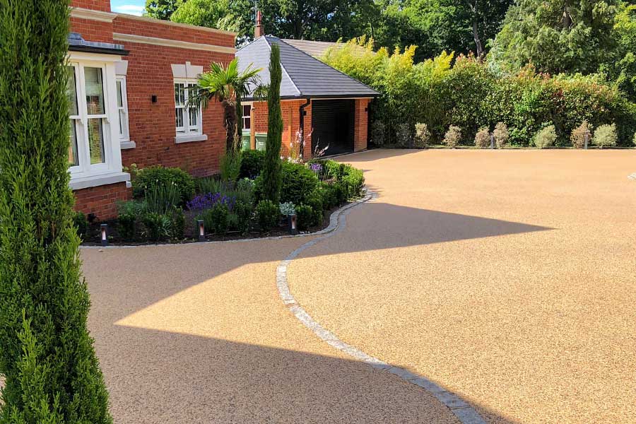 Example of a resin bound gravel driveway surfaced with Addagrip Stonebound in honey colour