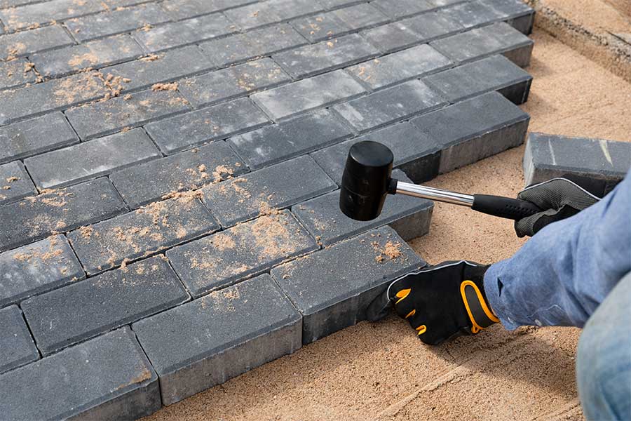 Landscaping contractor installing block paving for a new driveway
