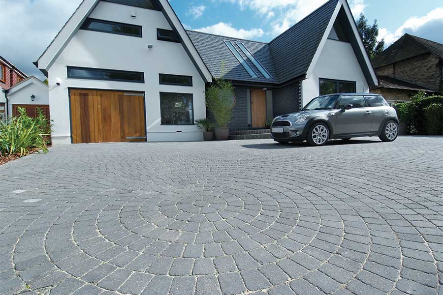 Large driveway surfaced with Brett Aplha graphite coloured block paving with 3 different sizes of paving block used