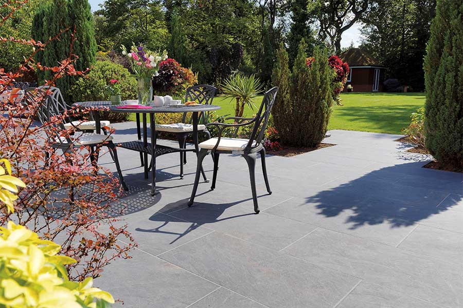 Sunny patio paved with Pavestone Dolomite grey porcelain paving slabs