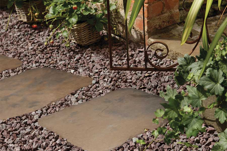 Pretty path created with random steeping stones surrounded by decorative gravel