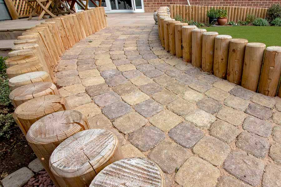 Very attractive curved garden path featuring cobble style rustic block paving