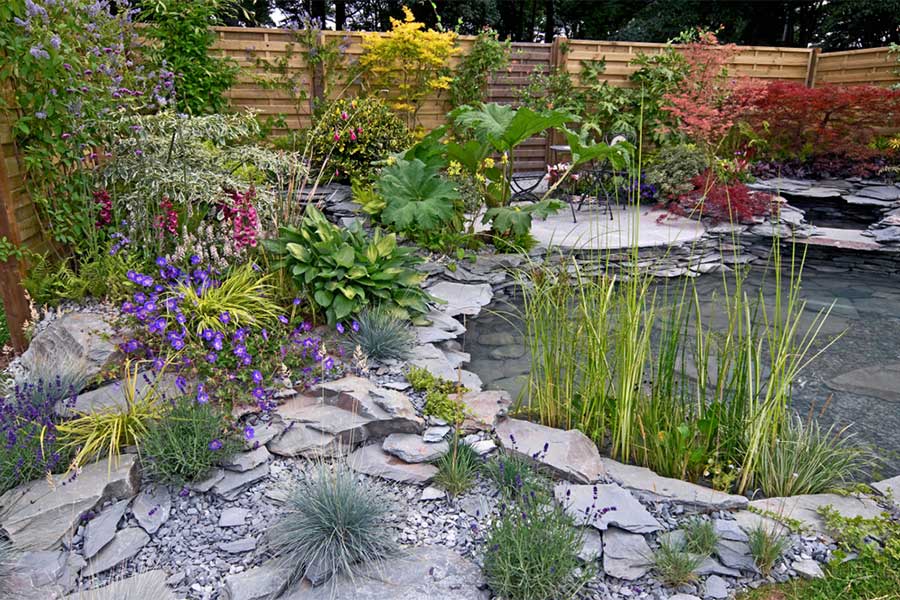 Lovely rockery garden with a pond and slate chippings