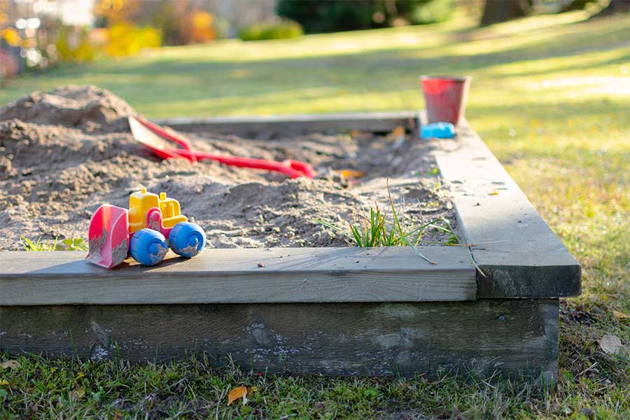 Softwood sleepers have been used to create this childs outdoor sand pit