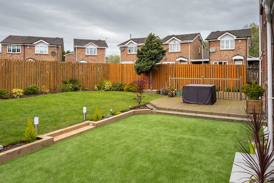 A large lawn edged with wooden garden sleepers