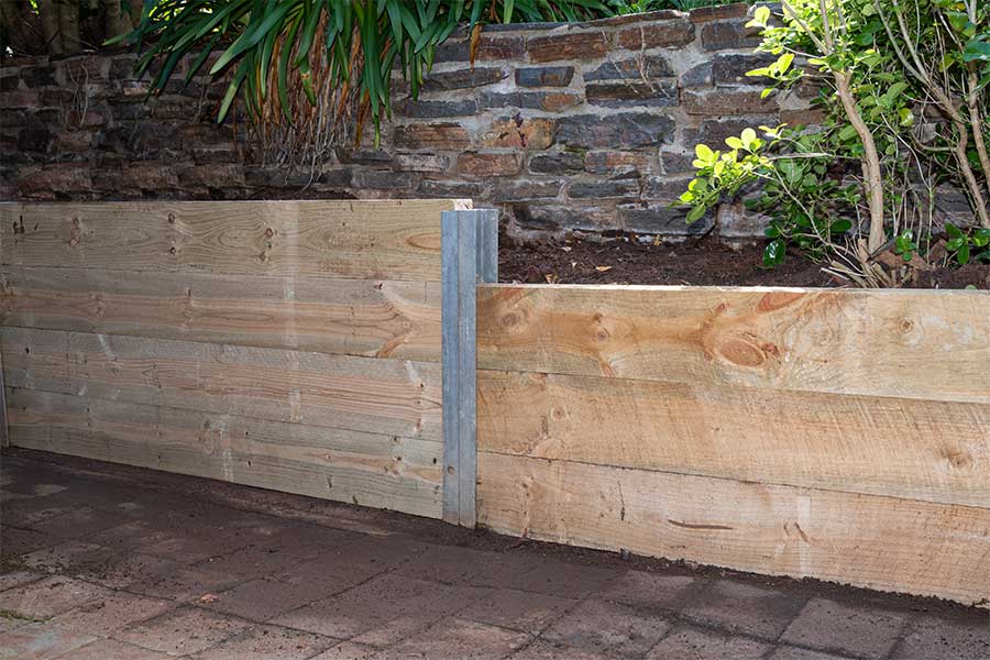 A wooden sleeper retaining garden wall
