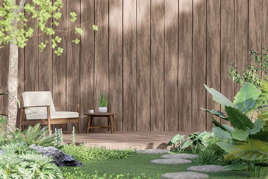 An attractive garden wind break created with vertical wooden garden sleepers