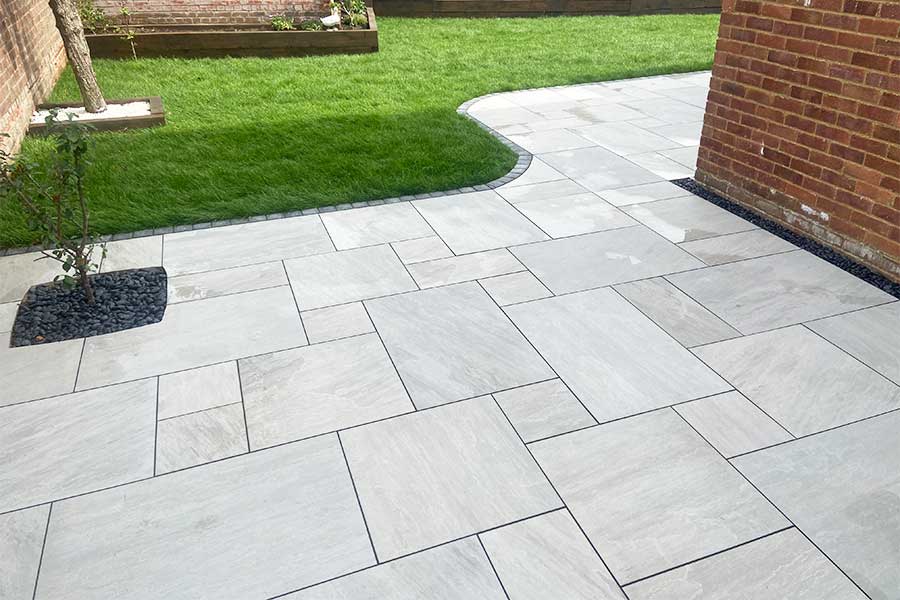 Patio paved with Stone Grey porcelain paving slabs