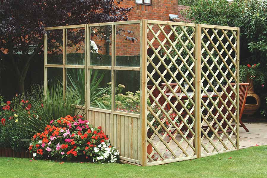 Entertaining area in a garden surrounded by trellis panels
