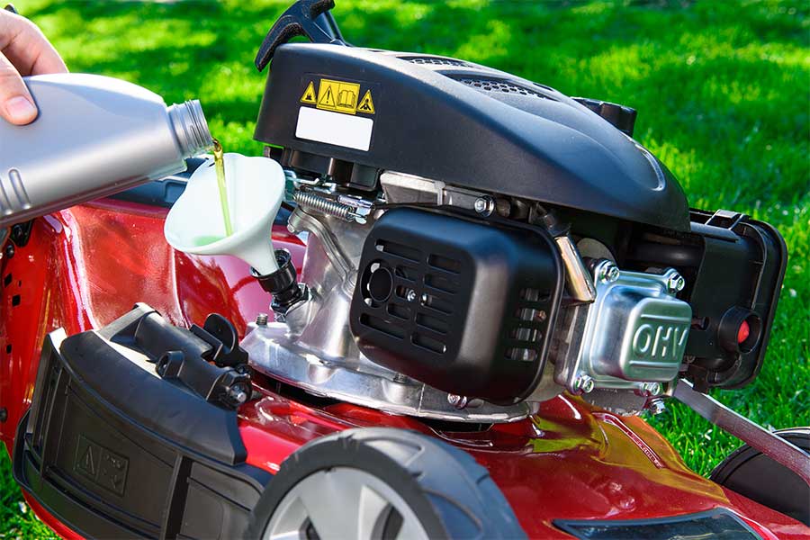 Changing the oil on a lawn mower before storing it away for winter